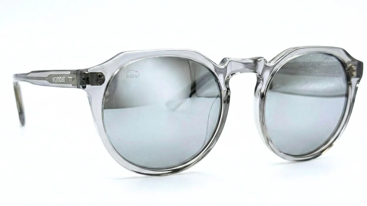 Wombat Gear clear frame sunglasses with silver mirrored lenses and wombat logo, shown at an angle on a white background