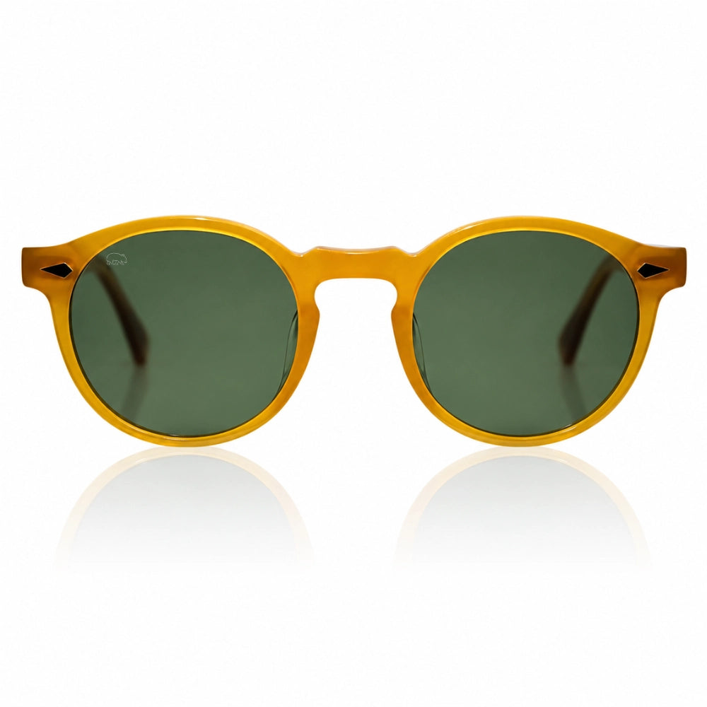 Round sunglasses with a translucent mustard yellow frame and dark green lenses, shown against a white background with a soft reflection below.