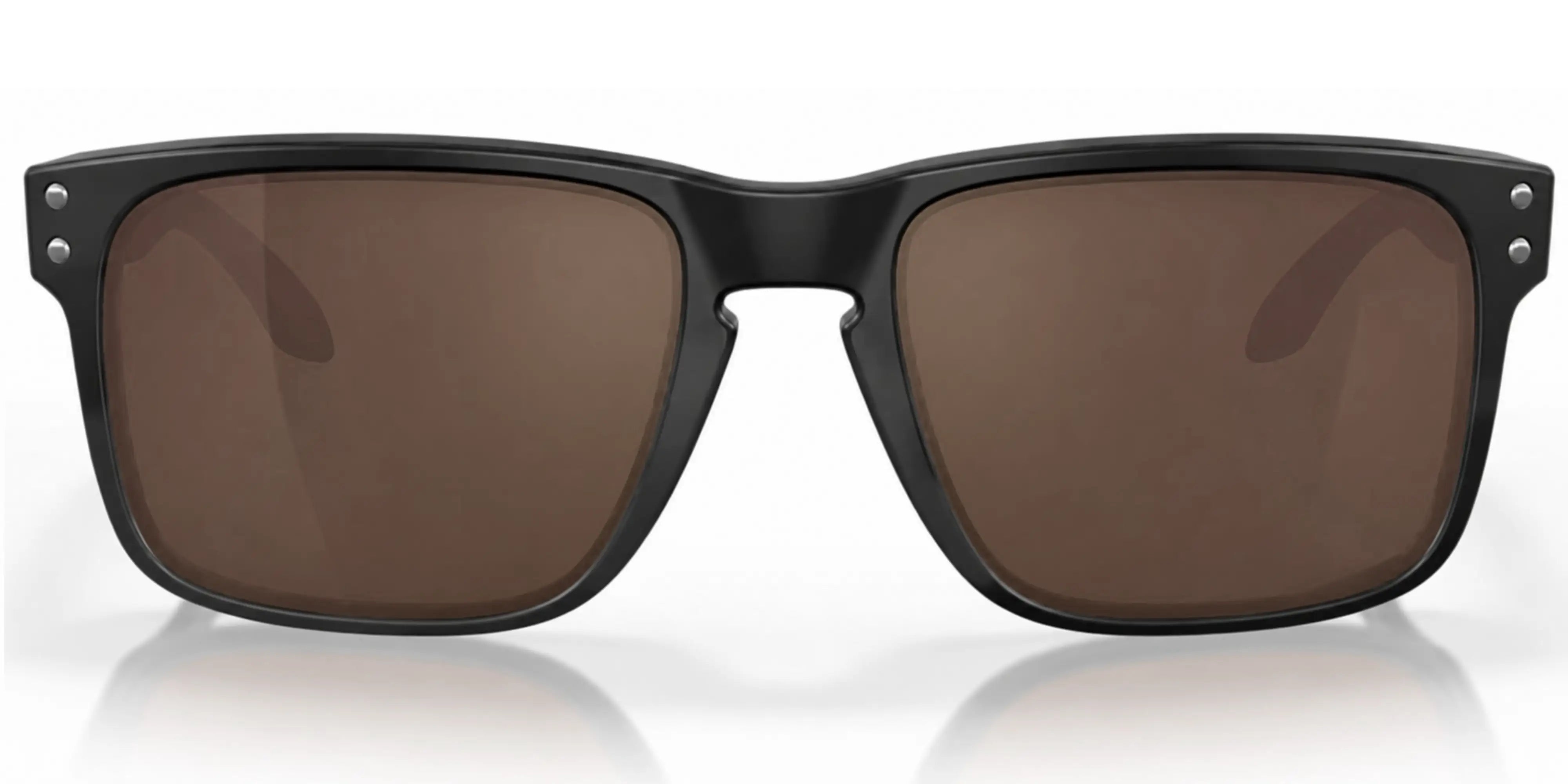Black Oakley sunglasses with brown lenses on a white background