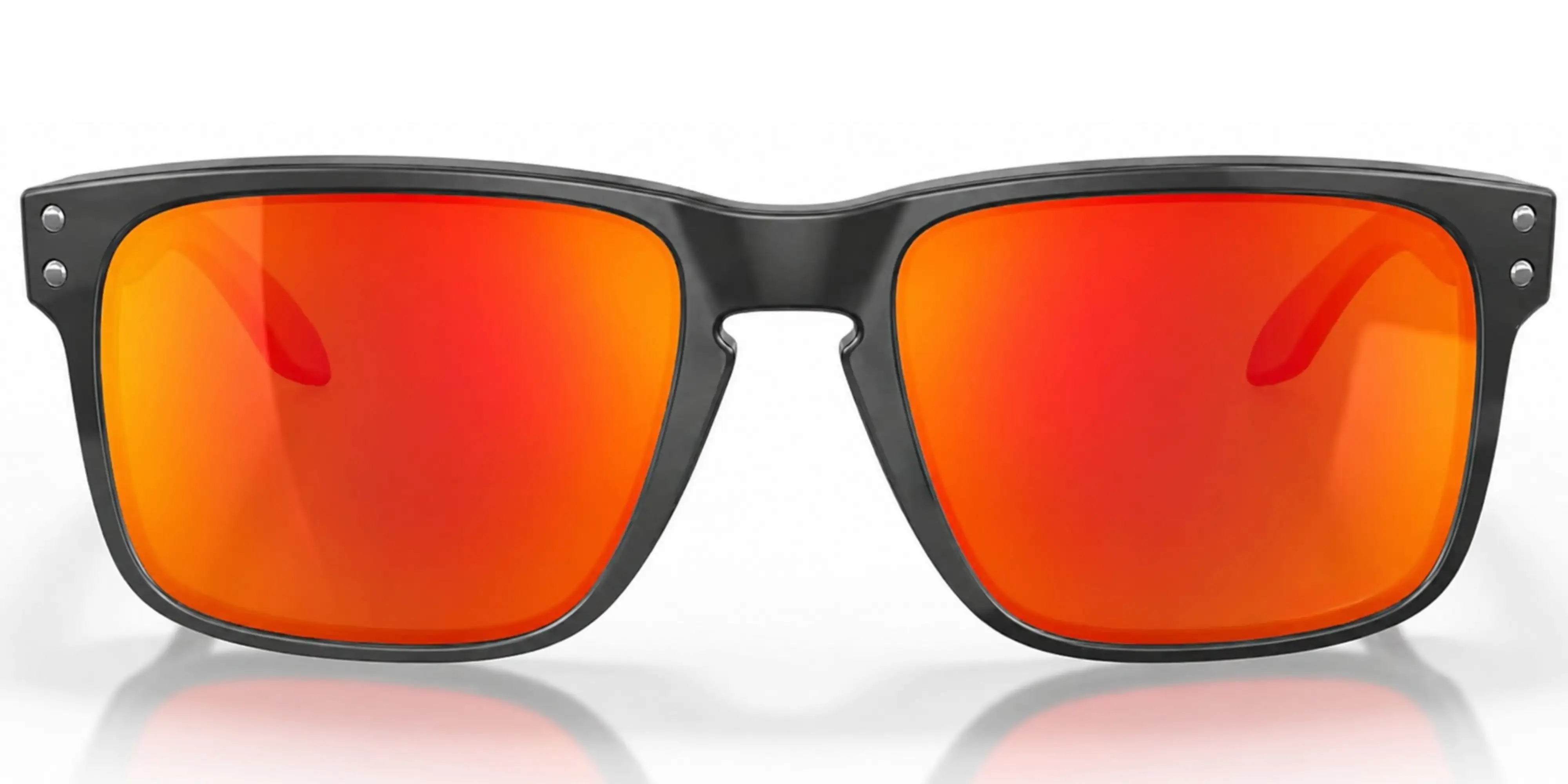 Oakley sunglasses with black frames and red-orange lenses on a white background